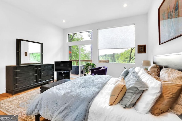 bedroom with access to outside, recessed lighting, and wood finished floors