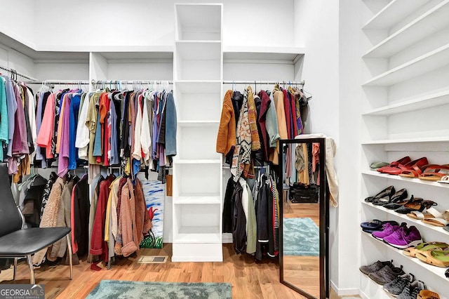 walk in closet with wood finished floors and visible vents