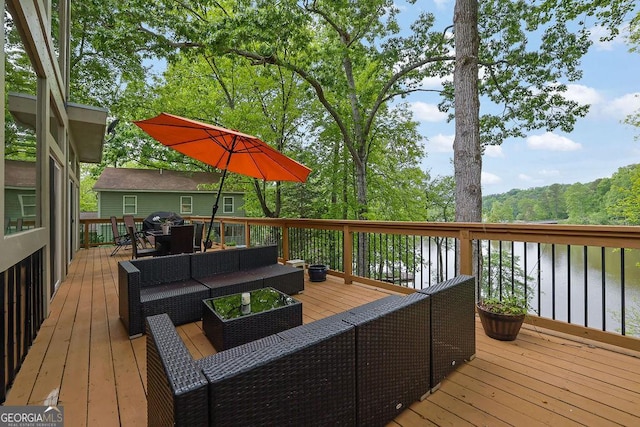 wooden terrace with grilling area, a water view, outdoor lounge area, and outdoor dining space