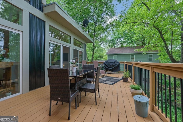 wooden deck featuring outdoor dining area and area for grilling