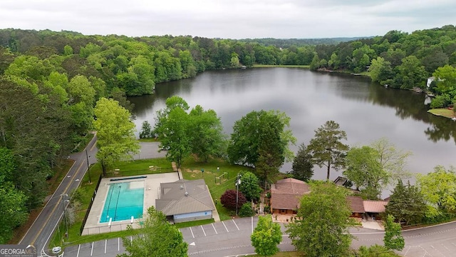aerial view with a water view and a forest view