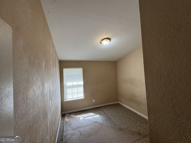 2863 Windsor Forrest Ct, Atlanta, GA 30349 - empty room with carpet flooring and a textured wall