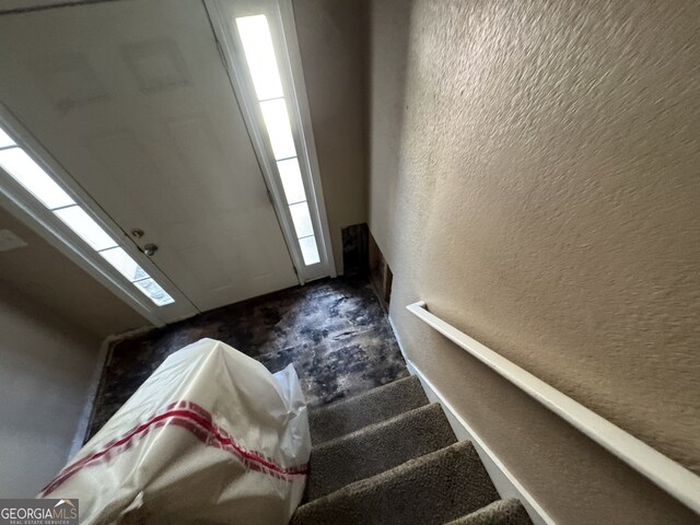 2863 Windsor Forrest Ct, Atlanta, GA 30349 - stairs with a textured wall and carpet