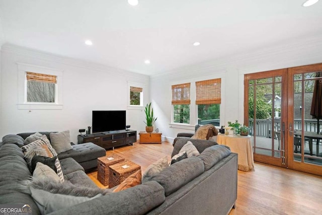 living area with french doors, ornamental molding, light wood finished floors, and recessed lighting