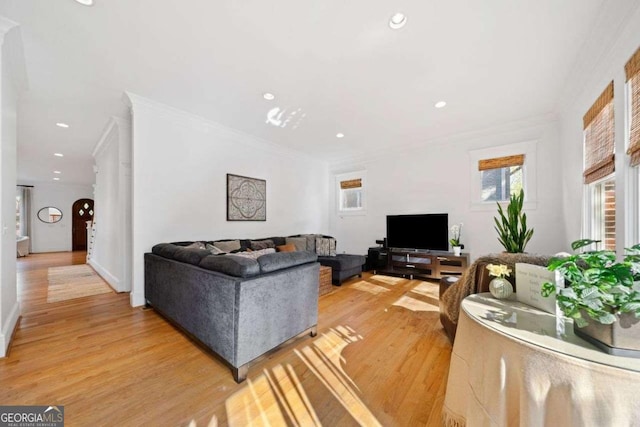 living area featuring light wood finished floors, recessed lighting, and ornamental molding