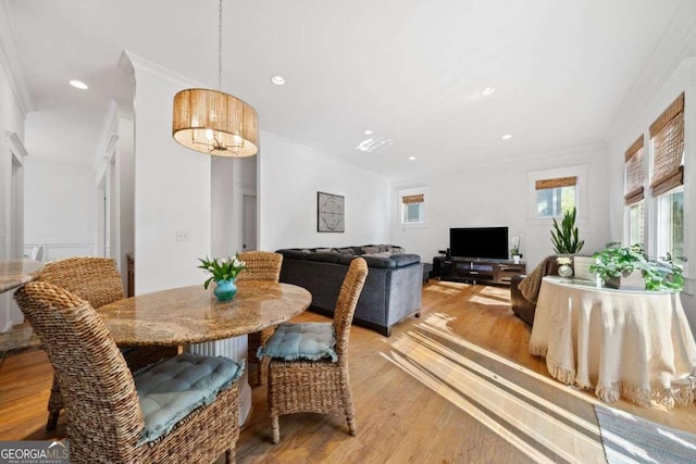 dining space featuring recessed lighting, light wood-style floors, and ornamental molding