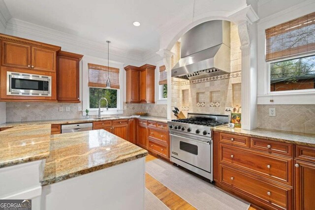 1181 Lanier Blvd NE, Atlanta, GA 30306 - kitchen with stainless steel appliances, brown cabinets, light stone counters, pendant lighting, and light wood finished floors