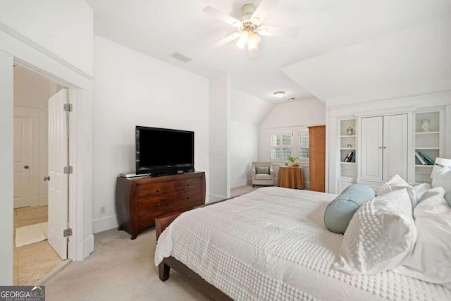 bedroom featuring baseboards, lofted ceiling, light colored carpet, and visible vents