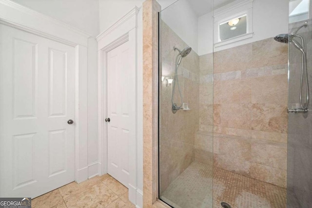 bathroom with tiled shower and tile patterned flooring