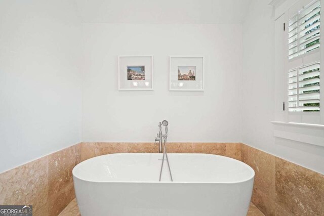 1181 Lanier Blvd NE, Atlanta, GA 30306 - full bath featuring a soaking tub, a wainscoted wall, and tile walls