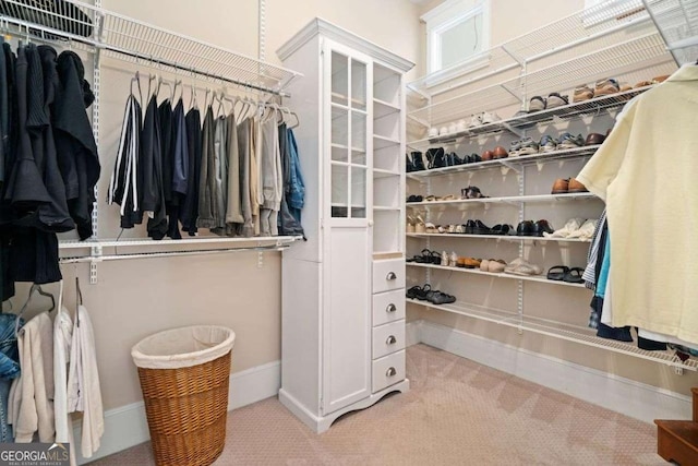 walk in closet with carpet floors