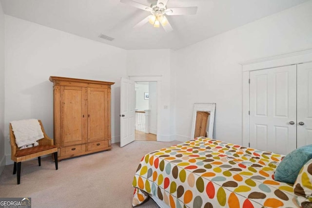 bedroom with light carpet, visible vents, a closet, and ceiling fan