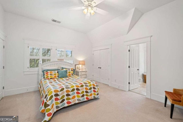 bedroom featuring vaulted ceiling, light carpet, ensuite bath, baseboards, and visible vents