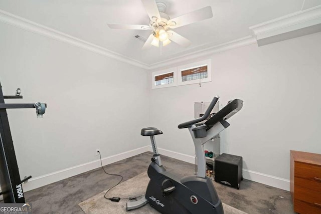 exercise area with baseboards, crown molding, and a ceiling fan