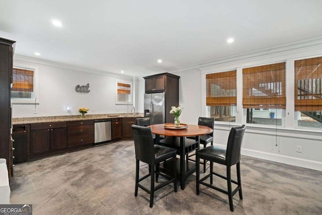dining room featuring baseboards, ornamental molding, and recessed lighting