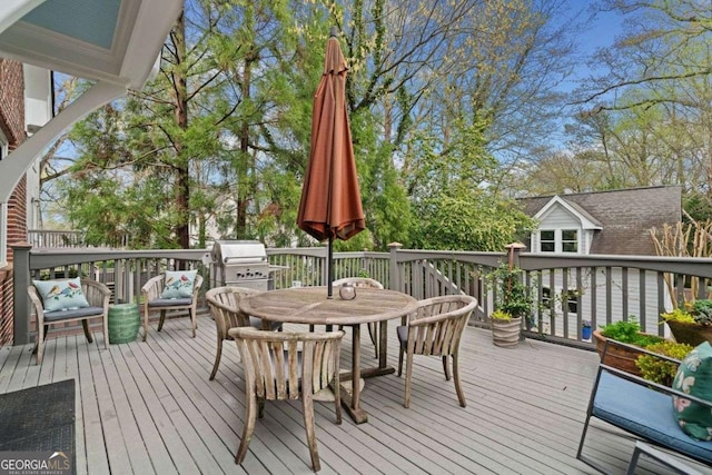 wooden deck featuring grilling area and outdoor dining space