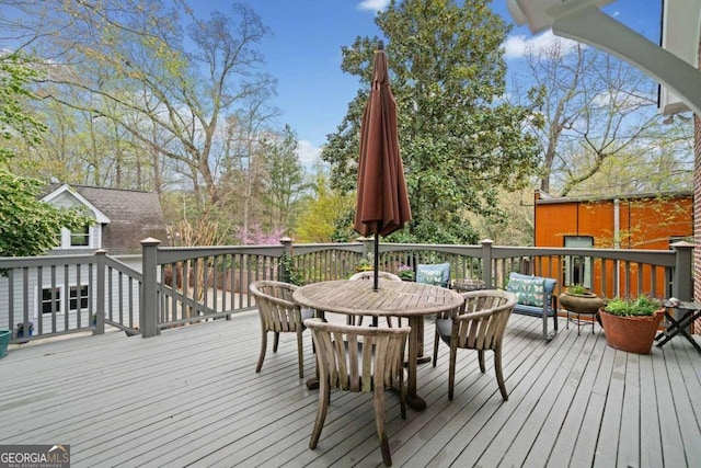 wooden terrace featuring outdoor dining space