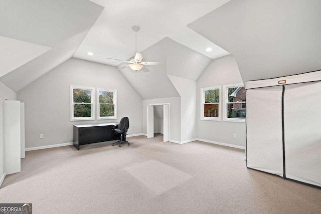 unfurnished office with baseboards, carpet flooring, a wealth of natural light, and vaulted ceiling