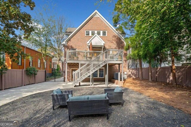 1181 Lanier Blvd NE, Atlanta, GA 30306 - back of property with brick siding, a wooden deck, stairs, and a fenced backyard