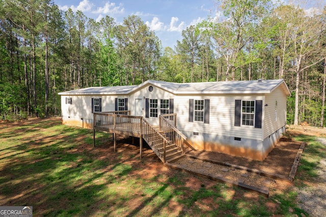 manufactured / mobile home featuring crawl space, stairs, and a wooden deck