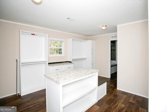 kitchen featuring white cabinets, visible vents, open shelves, light countertops, and dark wood-type flooring