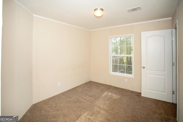 carpeted empty room featuring visible vents and ornamental molding