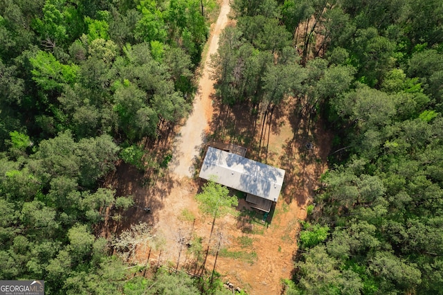 birds eye view of property with a view of trees