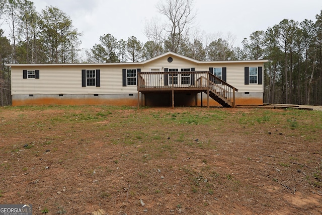 rear view of house with crawl space, stairs, and a wooden deck