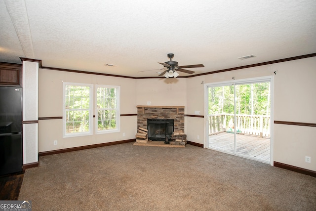 unfurnished living room featuring a textured ceiling, ceiling fan, carpet floors, baseboards, and visible vents