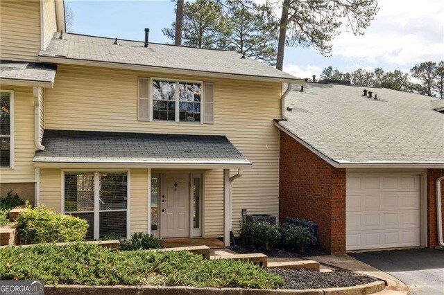 view of front of home with a garage and aphalt driveway