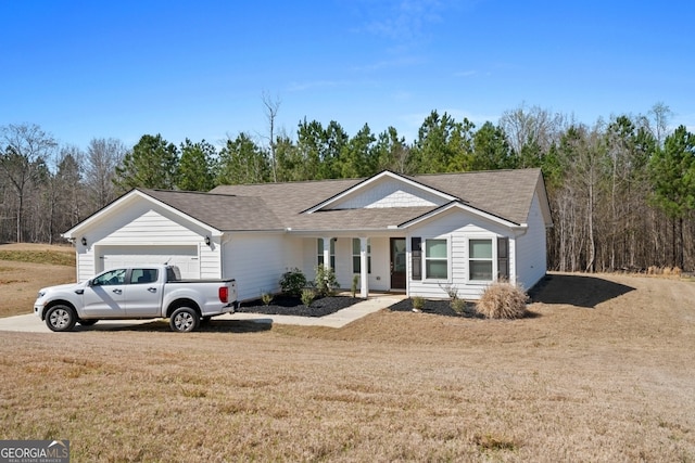 ranch-style house featuring covered porch, a front yard, a garage, and roof with shingles