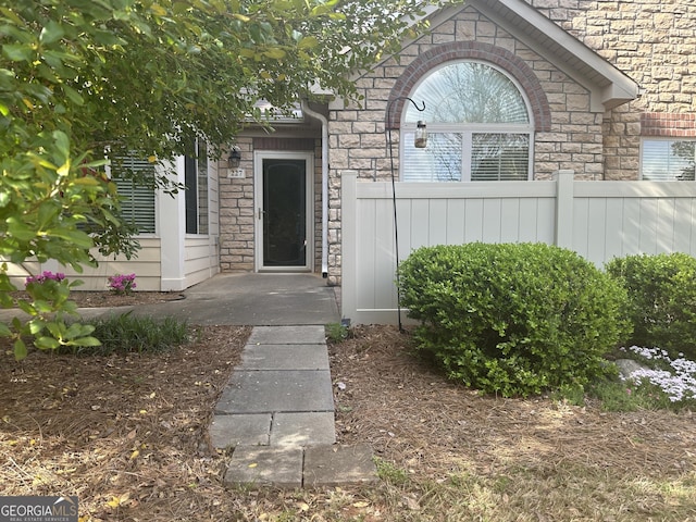 227 Fenwick Cir, Mcdonough, GA 30253 - property entrance featuring stone siding and fence