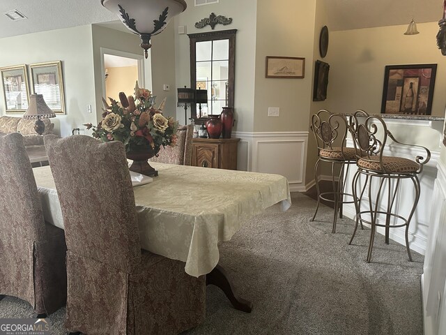 227 Fenwick Cir, Mcdonough, GA 30253 - carpeted dining area with wainscoting and plenty of natural light
