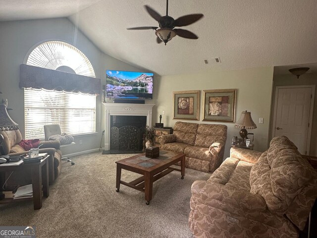 227 Fenwick Cir, Mcdonough, GA 30253 - carpeted living room with lofted ceiling, a ceiling fan, a textured ceiling, a fireplace, and baseboards