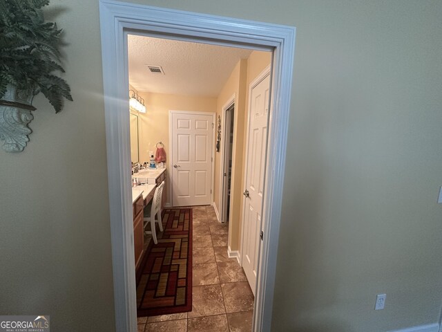 227 Fenwick Cir, Mcdonough, GA 30253 - bathroom with a textured ceiling, vanity, and baseboards