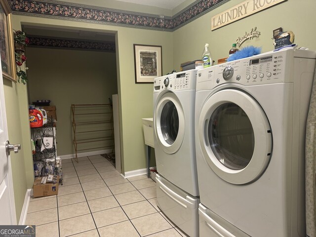 227 Fenwick Cir, Mcdonough, GA 30253 - laundry room featuring independent washer and dryer, light tile patterned floors, and baseboards