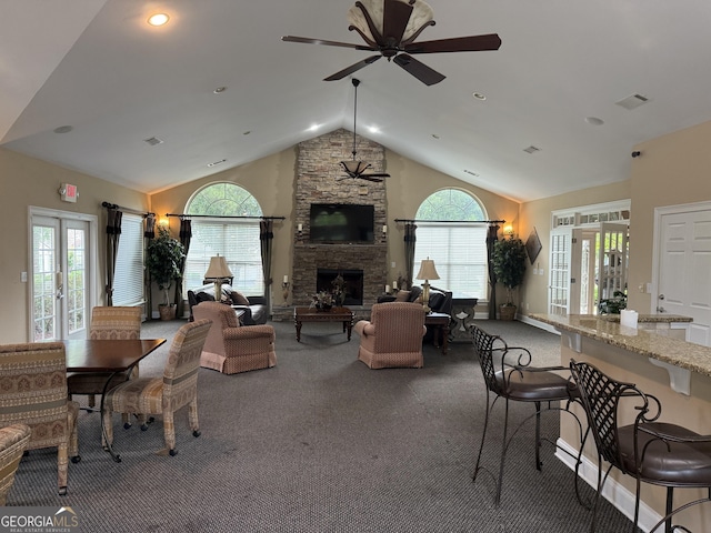 227 Fenwick Cir, Mcdonough, GA 30253 - living room with a ceiling fan, vaulted ceiling, carpet flooring, french doors, and a stone fireplace