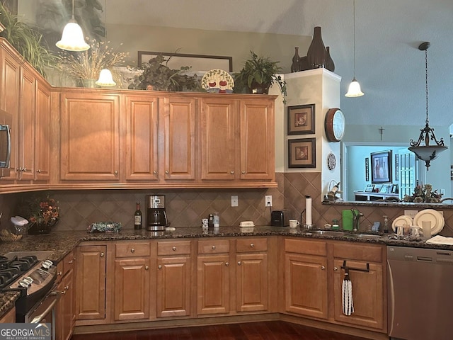 227 Fenwick Cir, Mcdonough, GA 30253 - kitchen with appliances with stainless steel finishes, a sink, backsplash, and dark stone counters