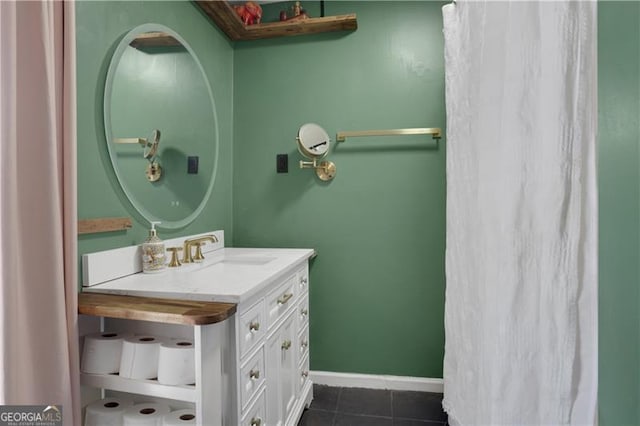 bathroom with tile patterned floors, vanity, and baseboards