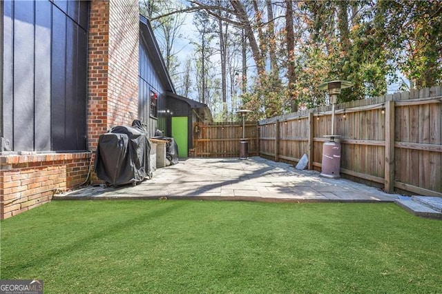 view of yard with a fenced backyard and a patio