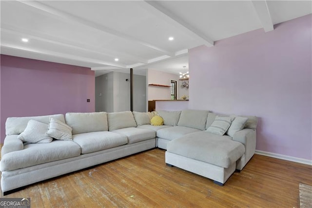 living area with beamed ceiling, recessed lighting, wood finished floors, a notable chandelier, and baseboards