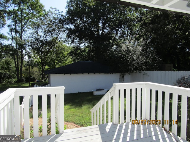 deck featuring fence and a yard