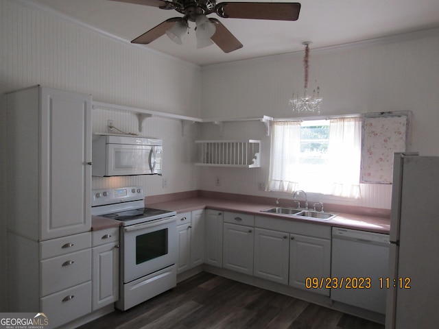 kitchen featuring light countertops, white appliances, dark wood-style flooring, ceiling fan with notable chandelier, and a sink