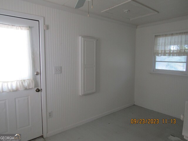 unfurnished room with wallpapered walls, ceiling fan, and a healthy amount of sunlight
