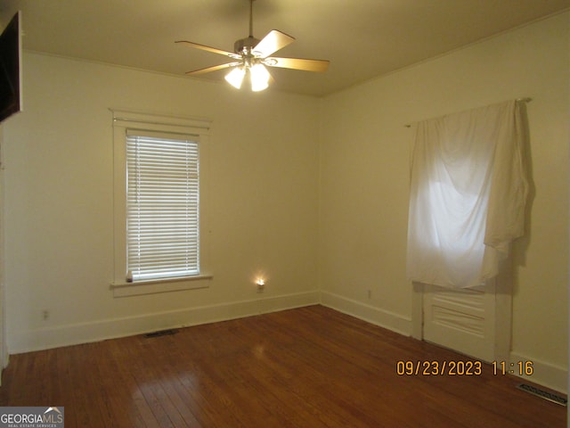 spare room featuring a ceiling fan, hardwood / wood-style flooring, baseboards, and visible vents