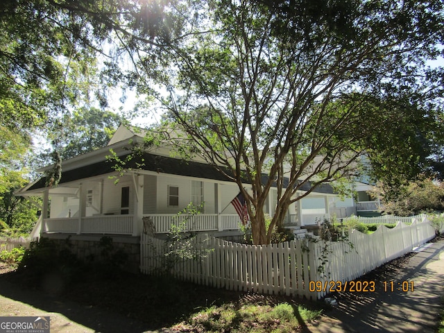 view of home's exterior featuring a fenced front yard and a porch