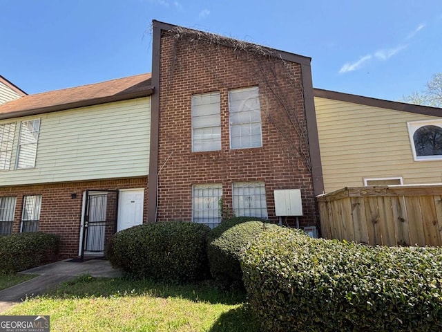 back of house with brick siding