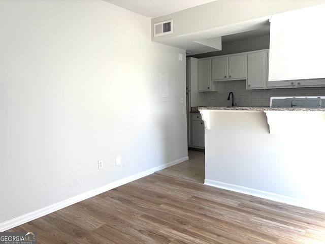 room details featuring stainless steel dishwasher and white cabinetry