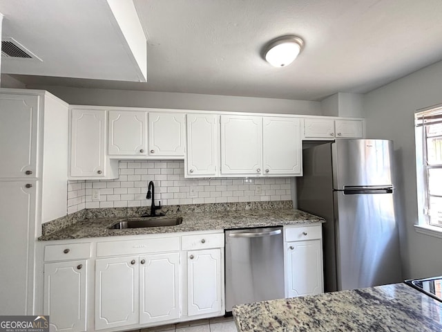 kitchen with white cabinets, decorative backsplash, and a sink