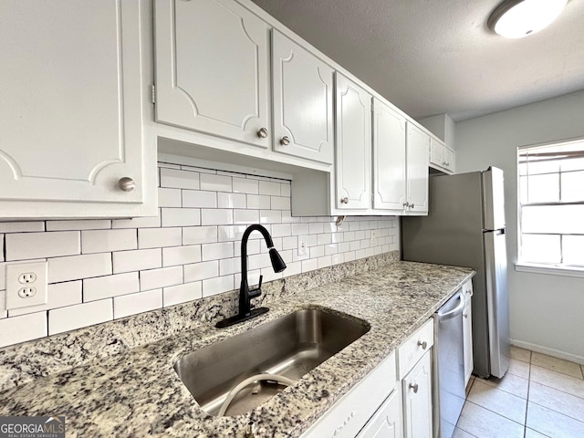 kitchen featuring white cabinetry, electric stove, backsplash, and light tile patterned floors